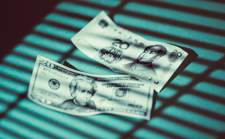 Shadow of Venetian blinds falls on US and Chinese banknotes 